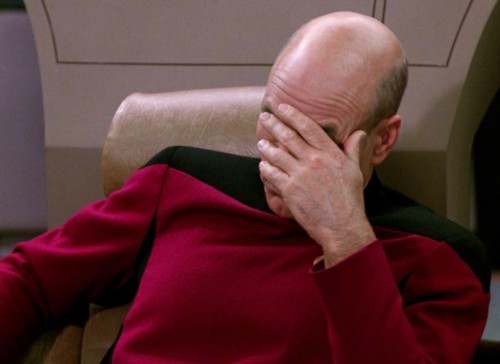 Person rubbing forehead dejectedly